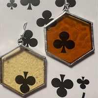 a pair of earrings with playing cards on them